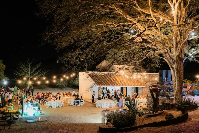 Outdoor wedding reception with string lights at night